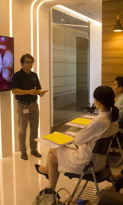 Dental expert presenting advanced topics in a classroom environment